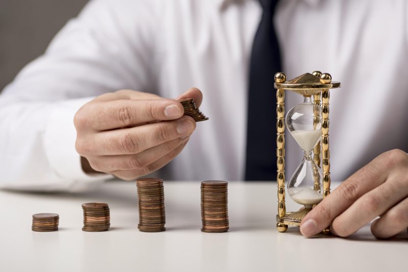 businessman with coins hourglass